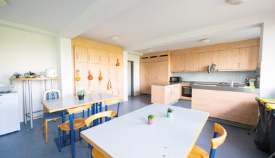 Communal kitchen with a large table and chairs
