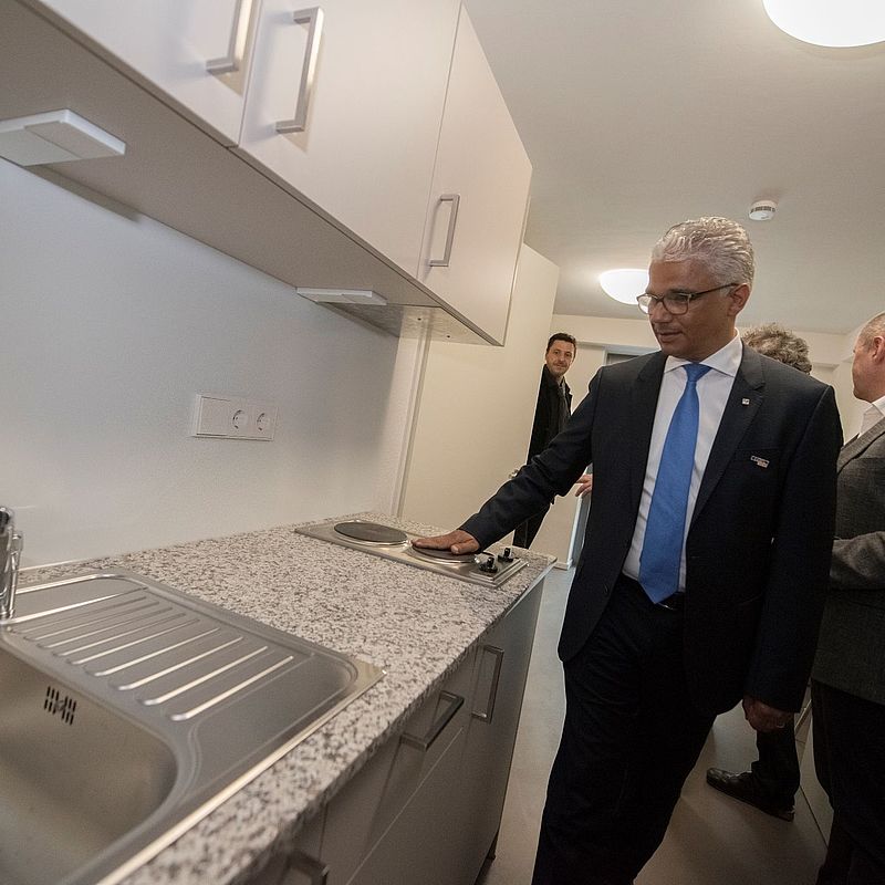 Oberbürgermeister schaut sich die Küchenzeile an